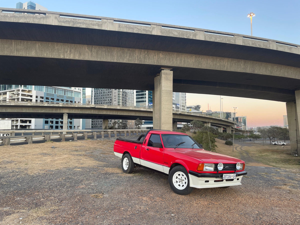 Red Ford Bantam under Cape Town flyovers