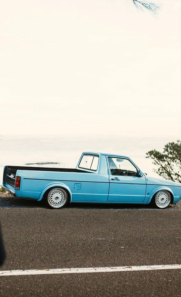 Low-angle view of a blue classic bakkie on the road