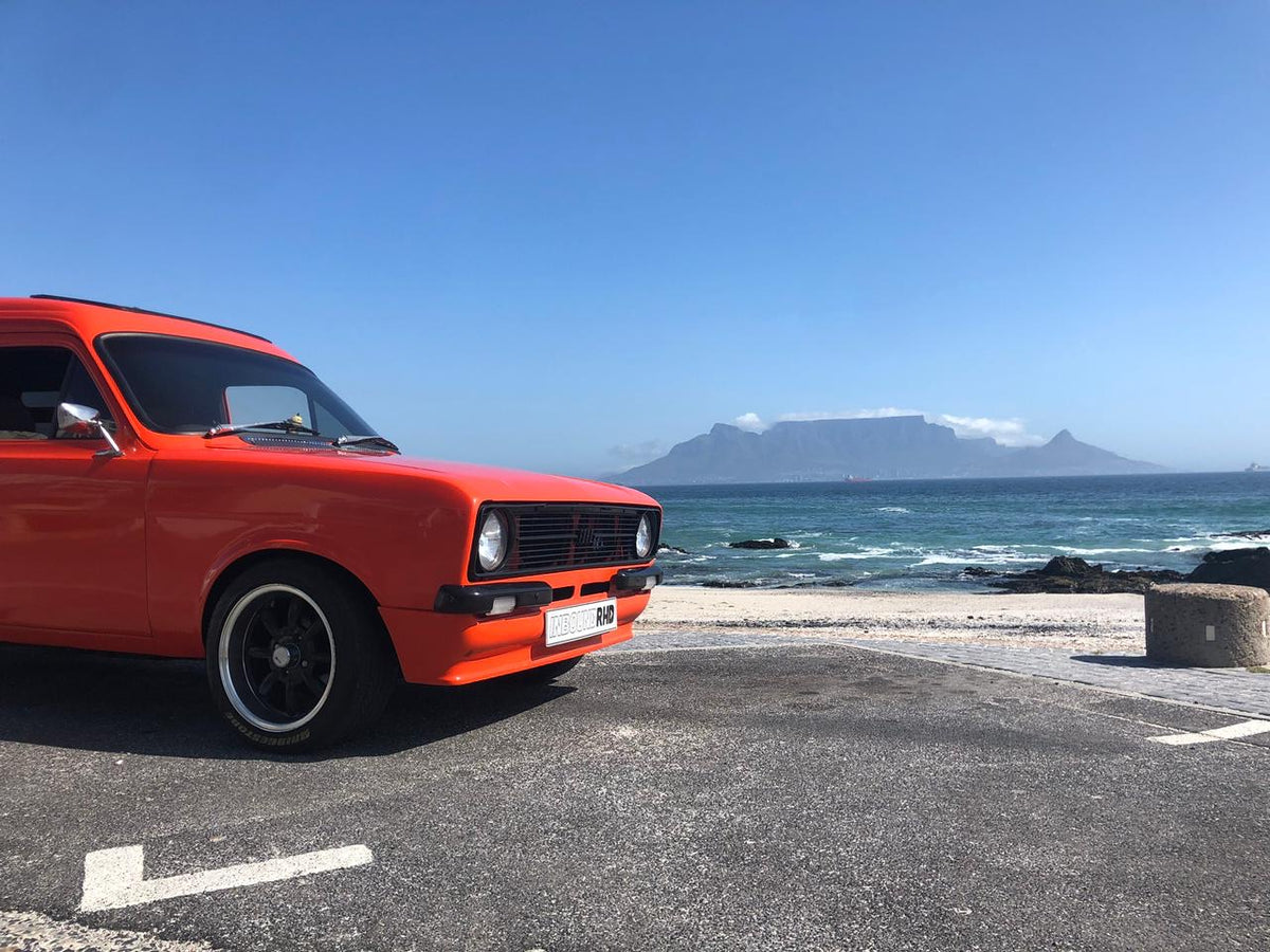 Orange panel van at the coastline