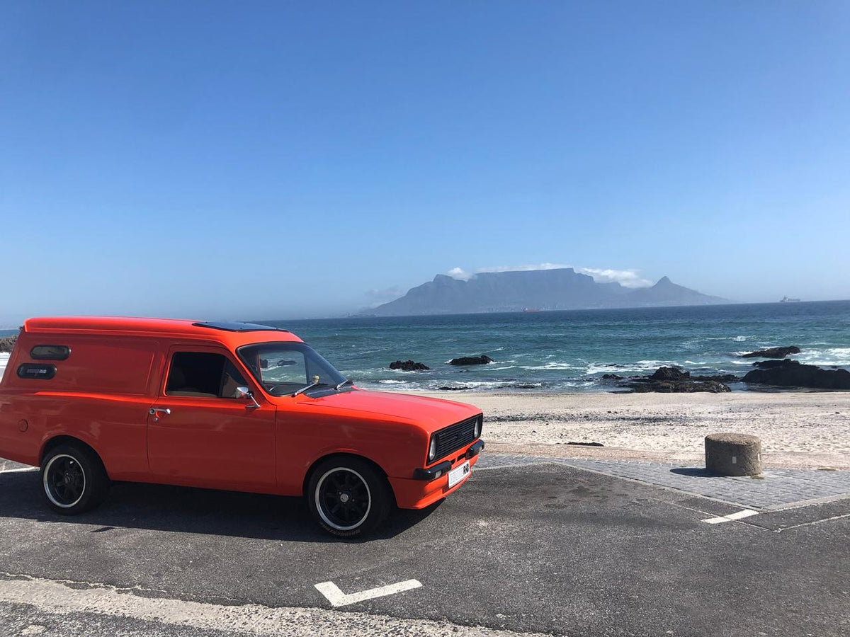Orange panel van with Table Mountain