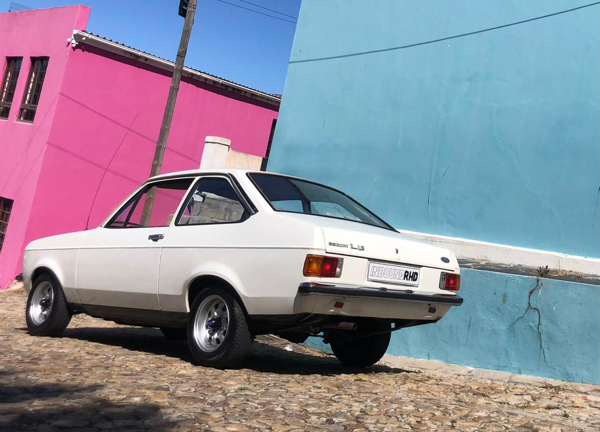 White Ford Escort against colorful Cape Town walls